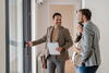 Realtor shows pregnant couple around an airy home